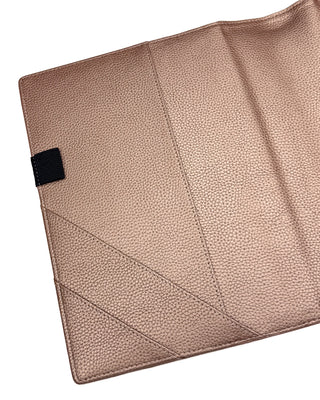 Rose gold vegan leather planner cover for discbound panners over a white background.