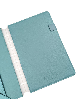 Light teal vegan leather back piece of a discbound planner cover with one elastic pen loop and a stamped Jane's Agenda logo over a white background.