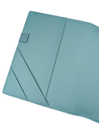 Teal textured fabric with a small rectangular tag on a white background