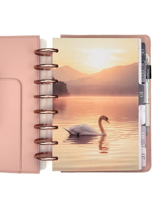 A swan on a lake at sunset design on a planner with Rose Gold discs and Blush Vegan Leather Cover. 
