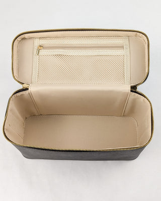 Inside view of a chocolate vegan leather train case with tan polyester fabric and a mesh zipper pouch.