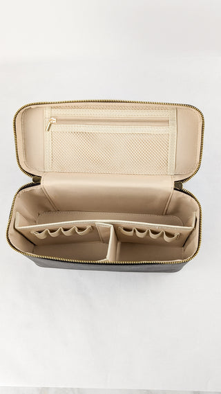 Overhead view of the inside of a chocolate brown vegan leather train case with a mesh zipper pouch and detachable dividers featuring eight pen loops.