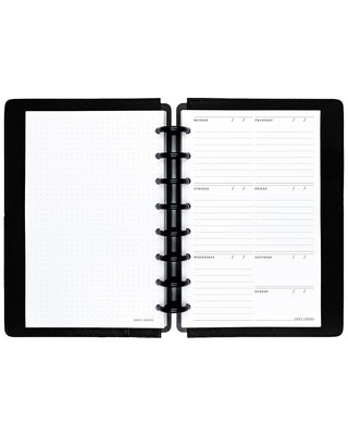 Open planner with black binding discs and leather cover on a white background