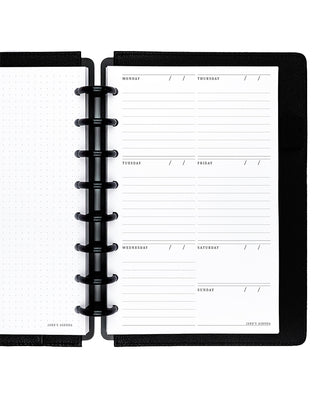 Black discbound planner with a weekly layout on a white background