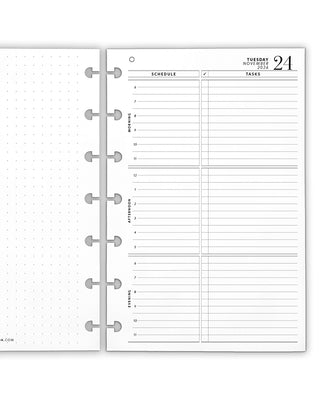 Two open discbound punched planner pages showing a daily schedule and dot grid layout on a white background.