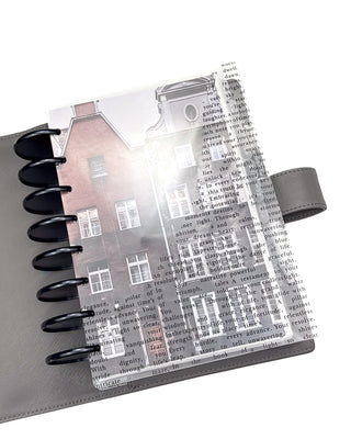 Planner with transparent cover featuring text and building illustration on a white background