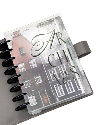 Jane's Agenda discbound planner "Archives" embossed printed plastic snap on cover with vintage European brick building cardstock dashboard, frosted monthly tabbed dividers, black metal binding discs, and gray vegan leather wrap