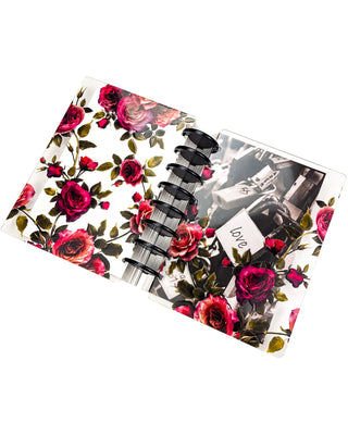 Featuring the front and back sides of the victorian-inspired vibrant rose glass clear plastic cover on a discbound planner. With Black binding discs on a white background. 
