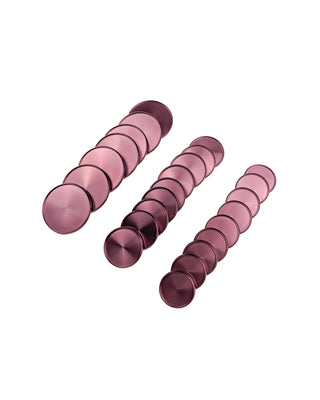 Three rows of violet purple circular planner binding discs on a white background