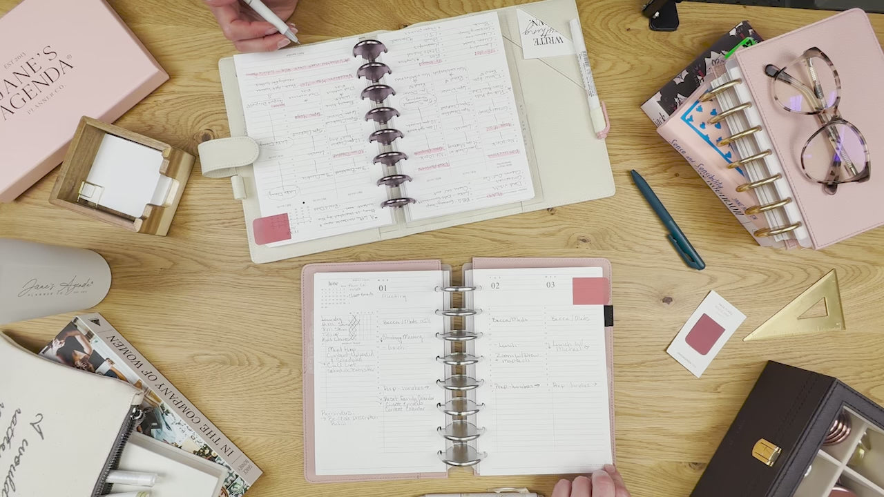 overhead view of planners on a desktop with planner inserts and other accessories