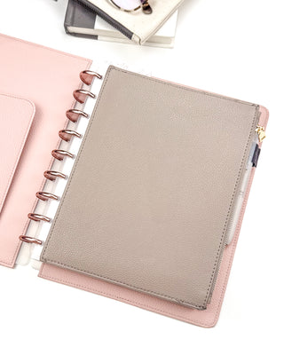 Taupe brown vegan leather discbound zipper pouch displayed inside a blush pink vegan leather snap-on cover, classic size, with rose gold discs on a white background.