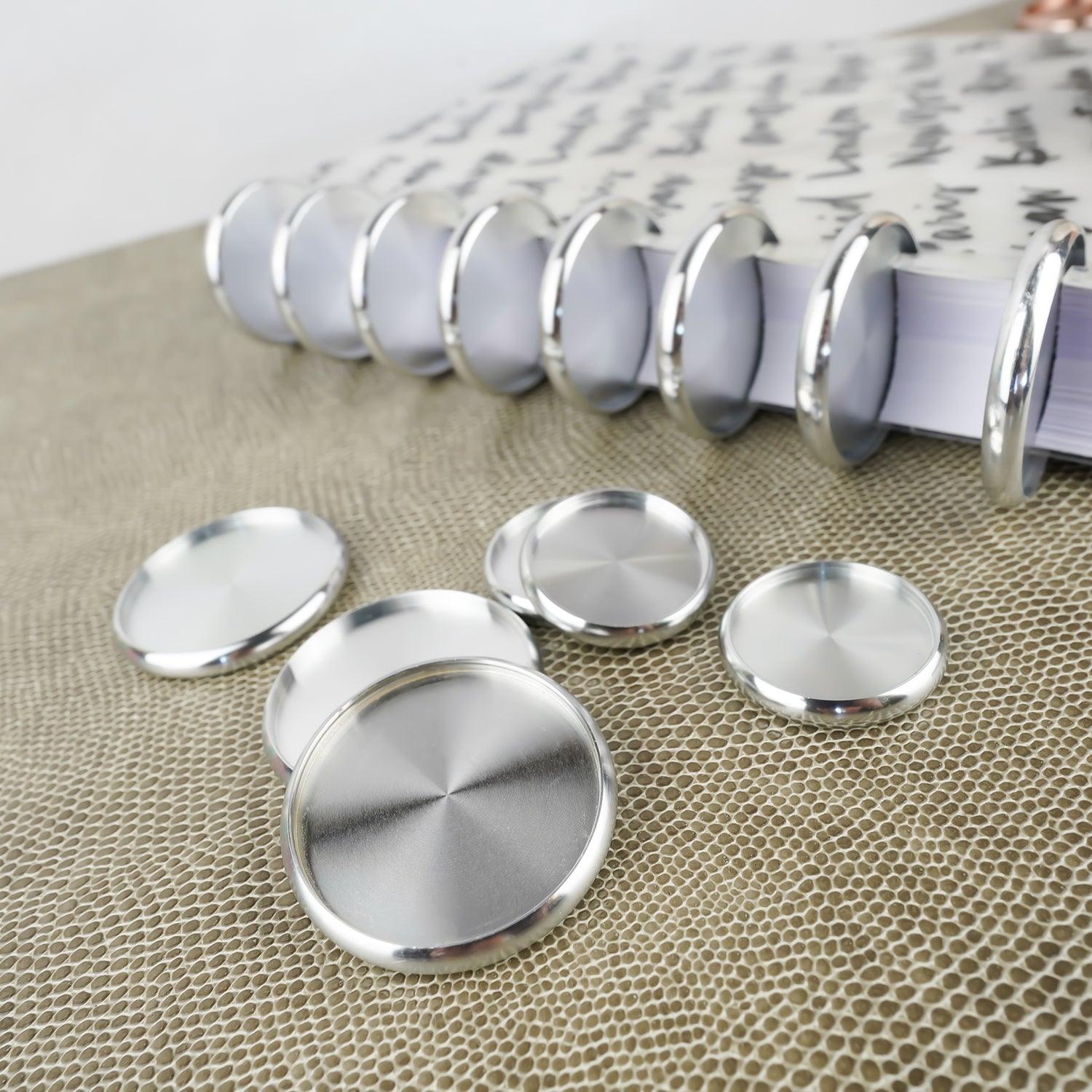 Metal planner binding expansion discs in silver from Jane's Agenda® featuring the Metropolitan disc-bound cover. 